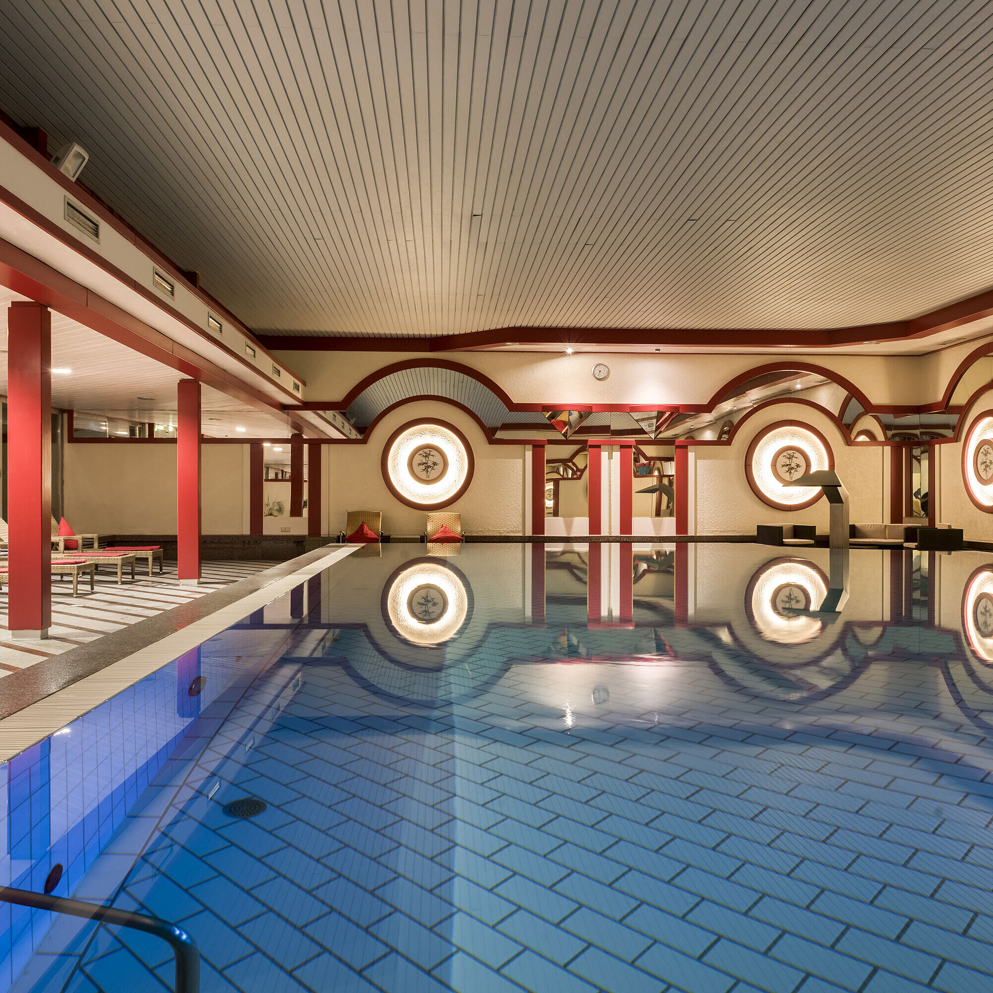 Spa area with loungers and large indoor pool at Maritim Hotel Bad Wildungen