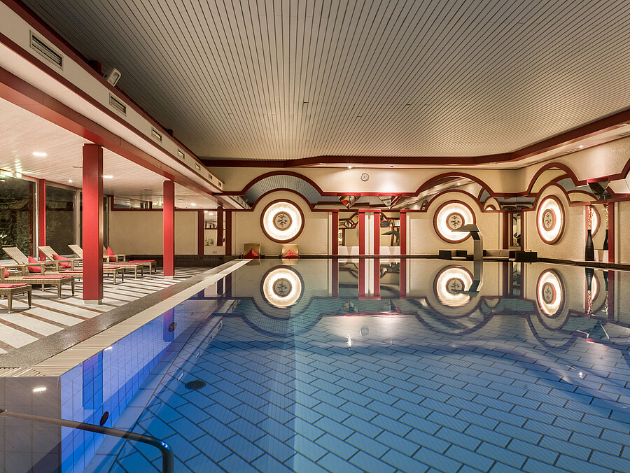 Spa area with loungers and large indoor pool at Maritim Hotel Bad Wildungen