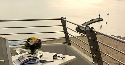 Balcony with sea view at Maritim Hotel Travemünde, table set with wine and flowers