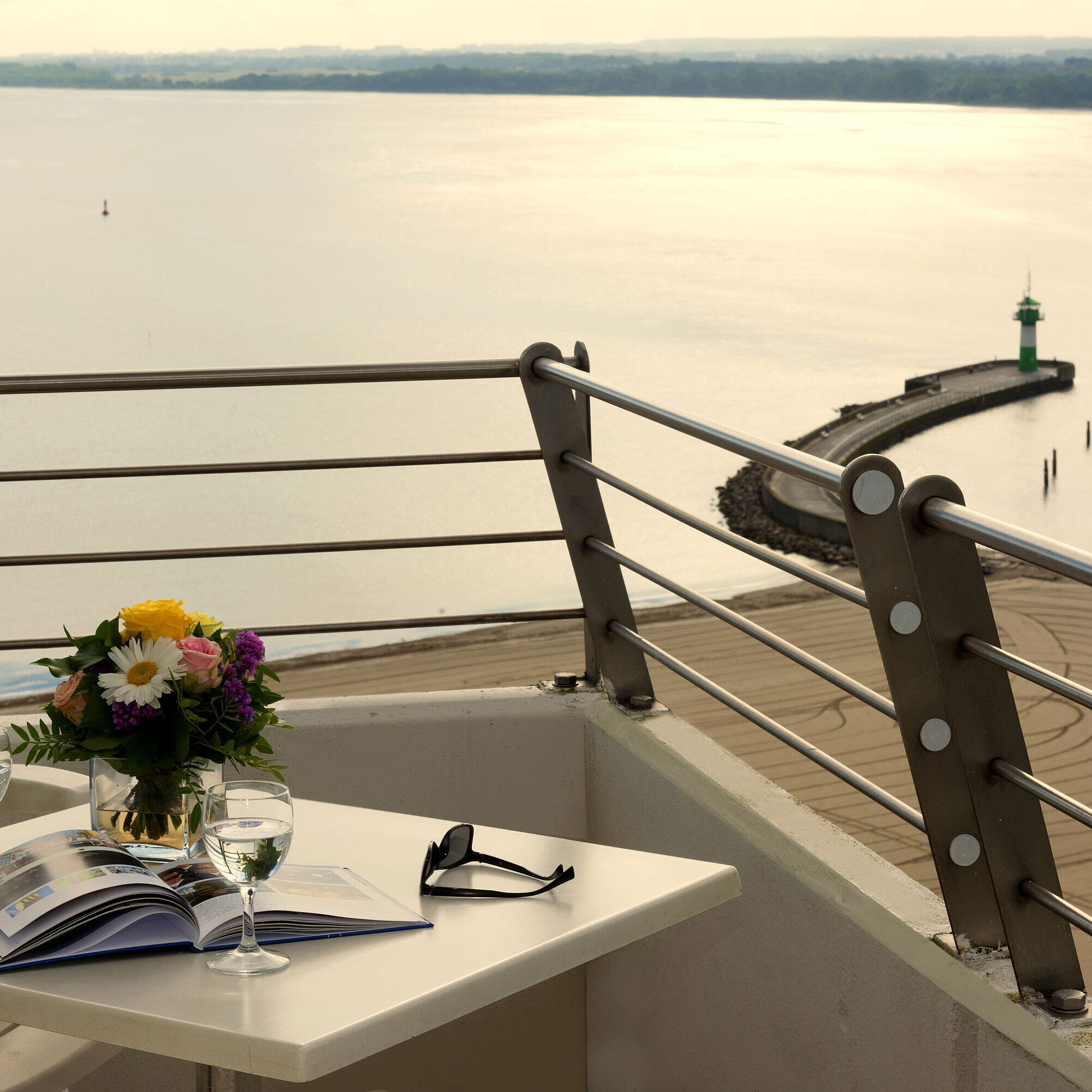 Balcony with sea view at Maritim Hotel Travemünde, table set with wine and flowers