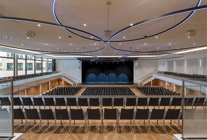 Large event hall at Maritim Hotel Ingolstadt with modern lighting and stage.
