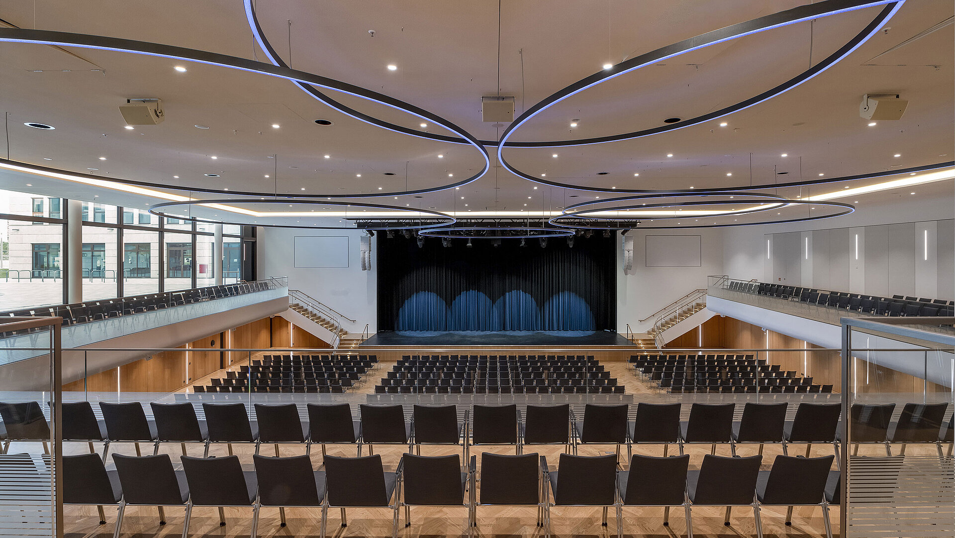 Large event hall at Maritim Hotel Ingolstadt with modern lighting and stage.