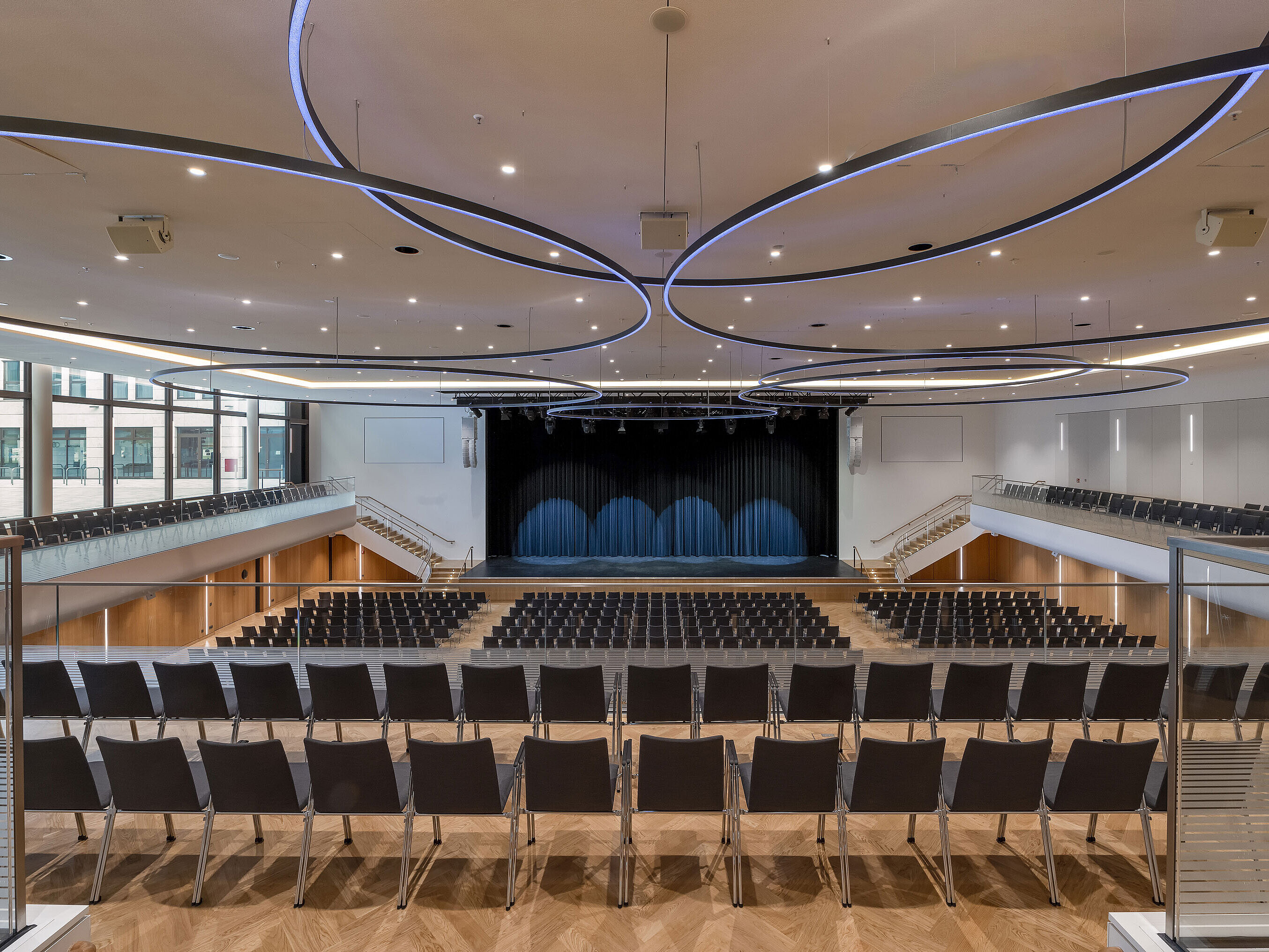 Large event hall at Maritim Hotel Ingolstadt with modern lighting and stage.