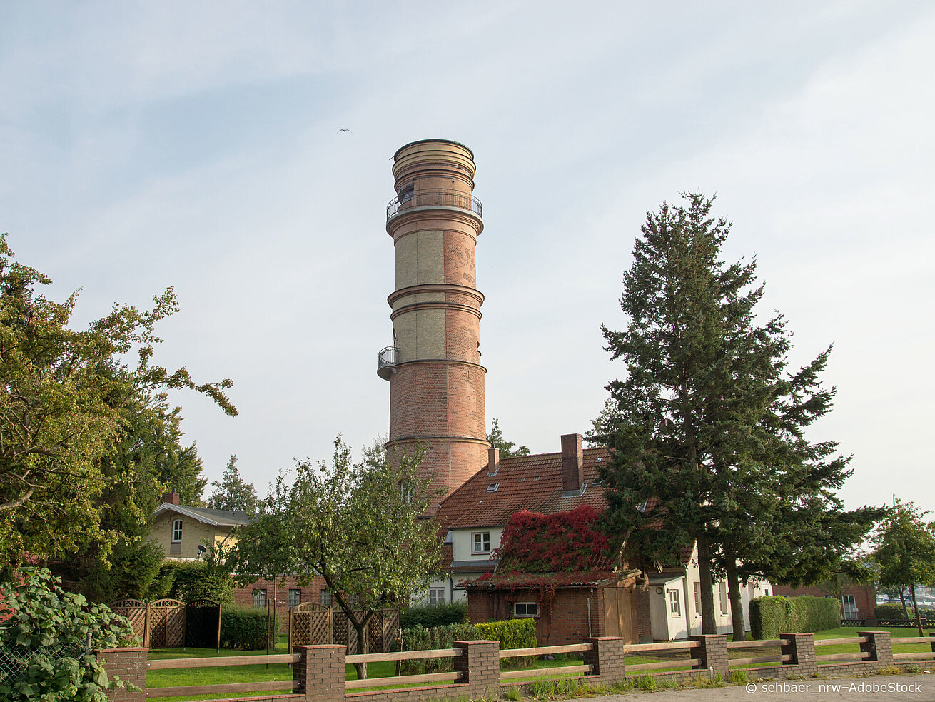 Old lighthouse in Travemünde made of brick, historic landmark on the Baltic Sea coast