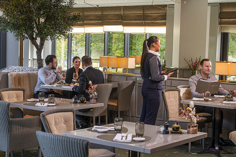 Restaurant Bottaccio at Maritim Hotel Düsseldorf with elegant decor, guests dining, and friendly service staff.