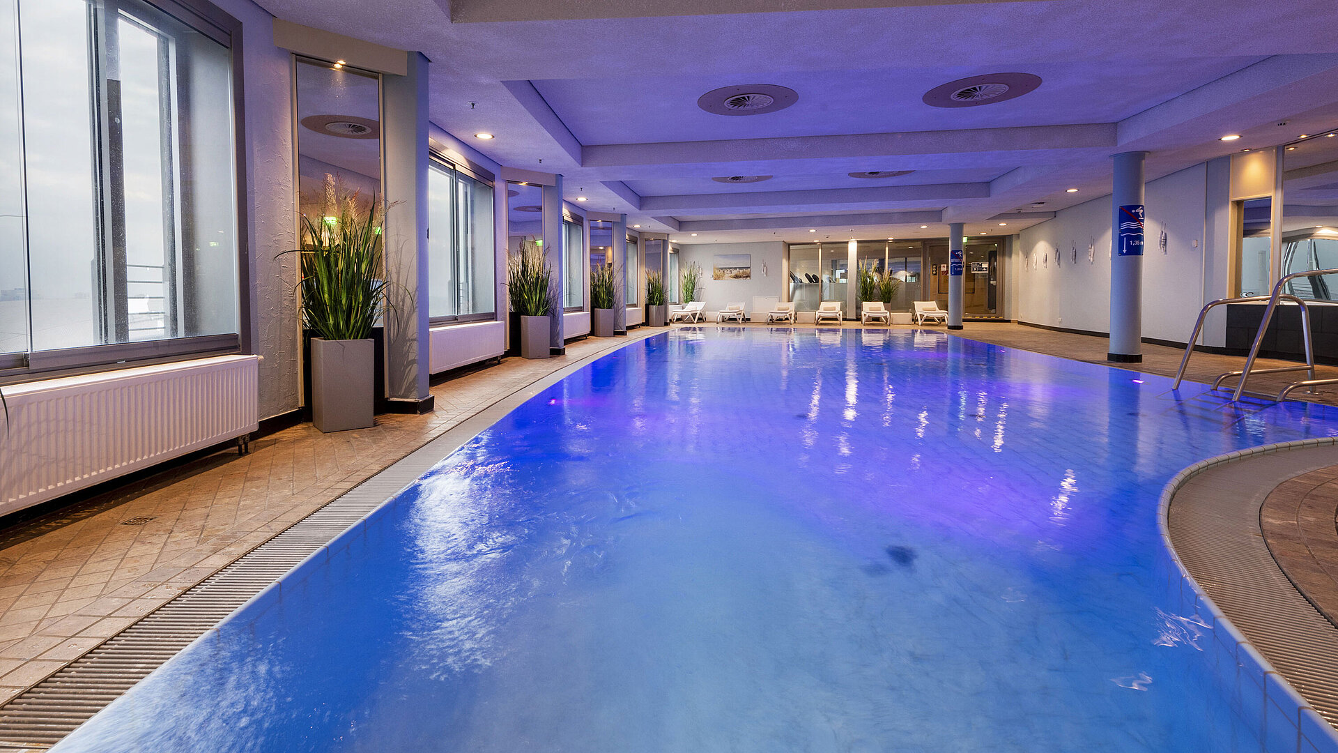 Illuminated indoor pool at Maritim Hotel Frankfurt with a relaxing atmosphere and panoramic windows.