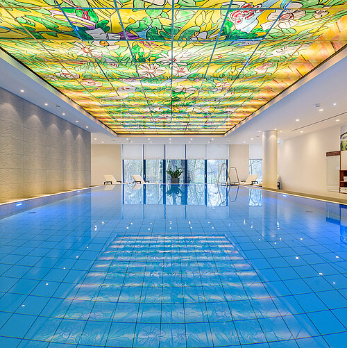 Elegant pool area at Maritim Hotel Bremen with colorful glass ceiling and modern lighting,perfect for wellness and relaxation