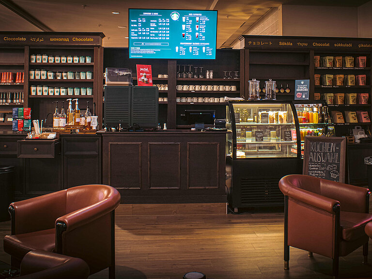 Café at the Maritim Hotel Bonn with Starbucks coffee, snack counter, cake display and cosy seating in a modern setting