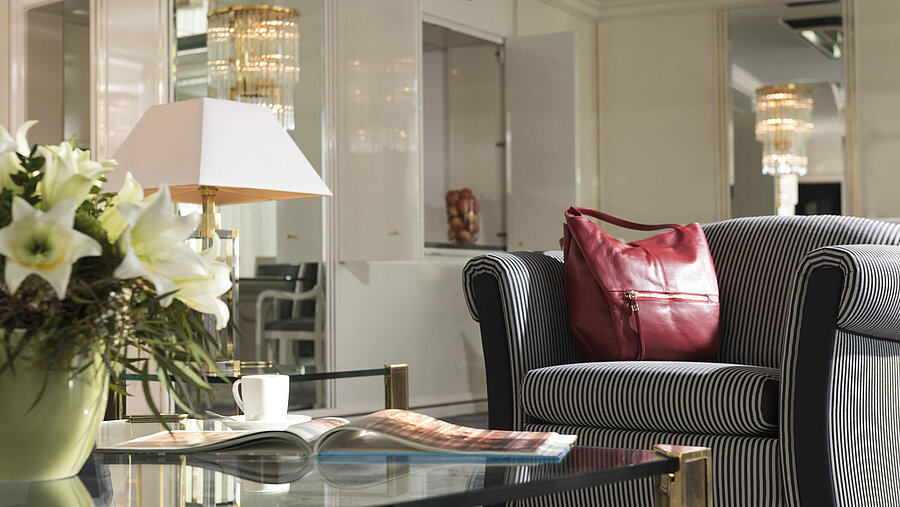 Detail in the suite at Maritim Hotel Ulm with striped armchair, red handbag and lilies