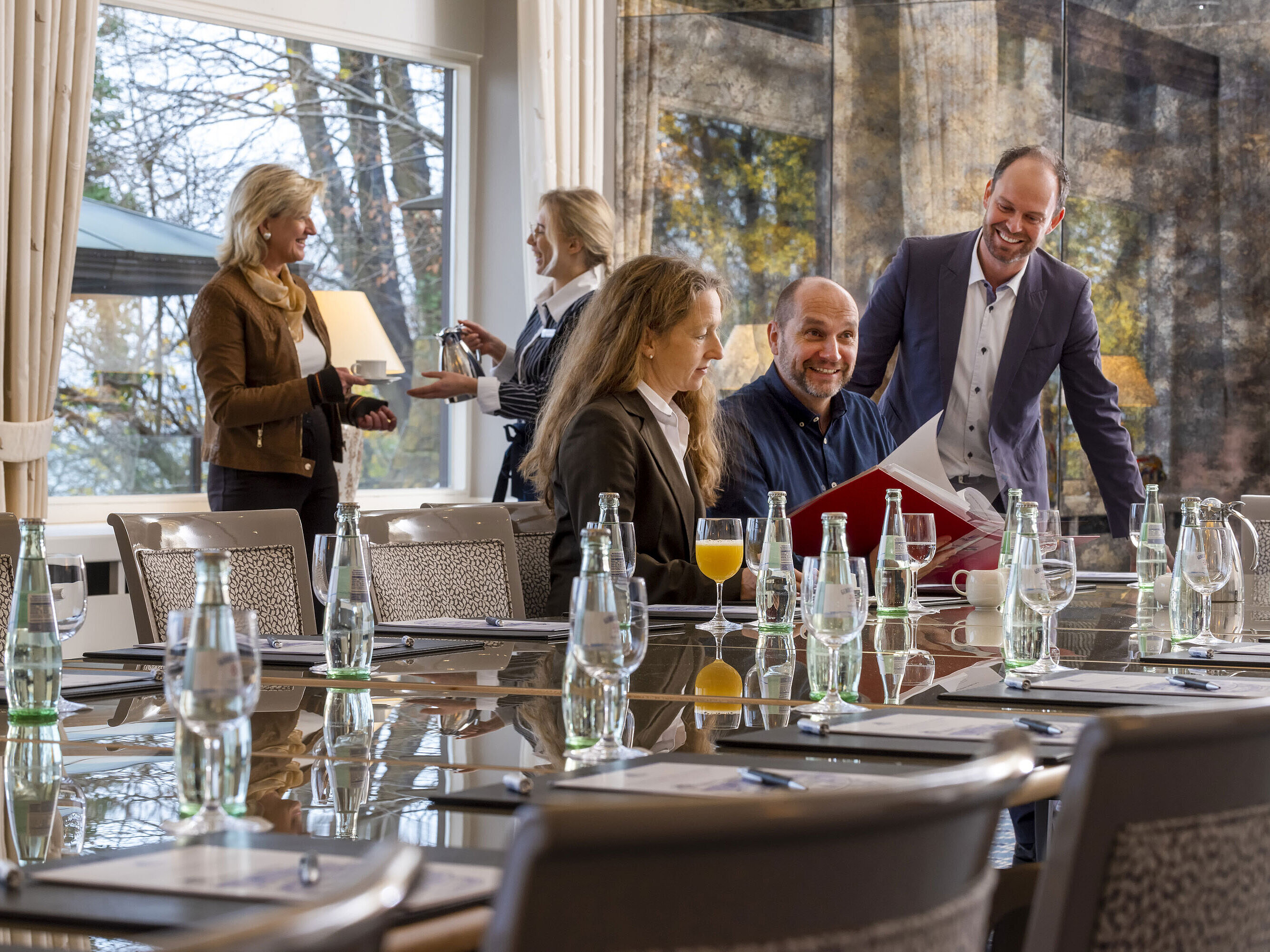 Salon Oslo in the Maritim Hotel Kiel, participants in a meeting, relaxed atmosphere with drinks and friendly service.