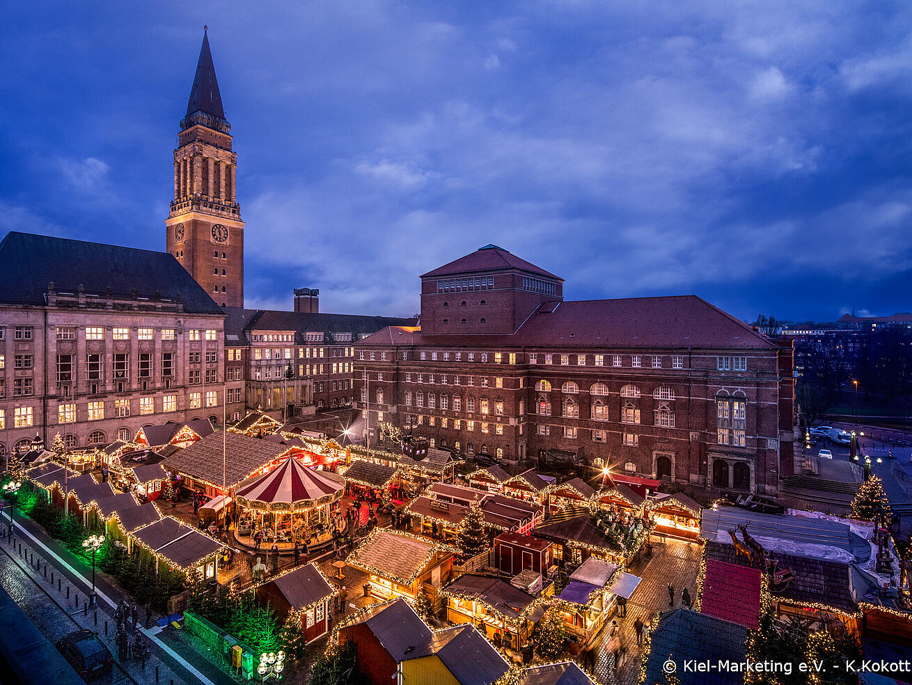 Kiel Christmas market at town hall Christmas market in front of Kiel town hall with lights stalls and carousel at evening