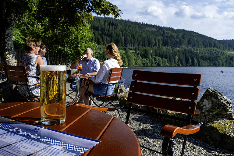 Fresh beer on the table in the beer garden of Maritim Hotel Titisee by the lake shore