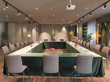 Stylish space at Maritim Hotel Plaza Tirana with U-shape seating, screen and fresh flowers