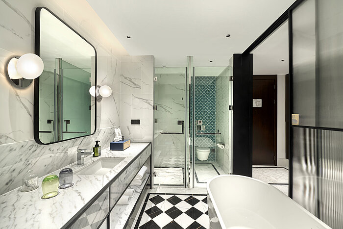 Elegant bathroom with marble design, large shower and modern amenities at Maritim Hotel Taicang
