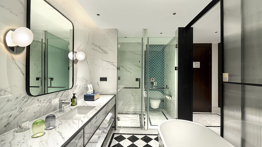 Elegant bathroom with marble design, large shower and modern amenities at Maritim Hotel Taicang