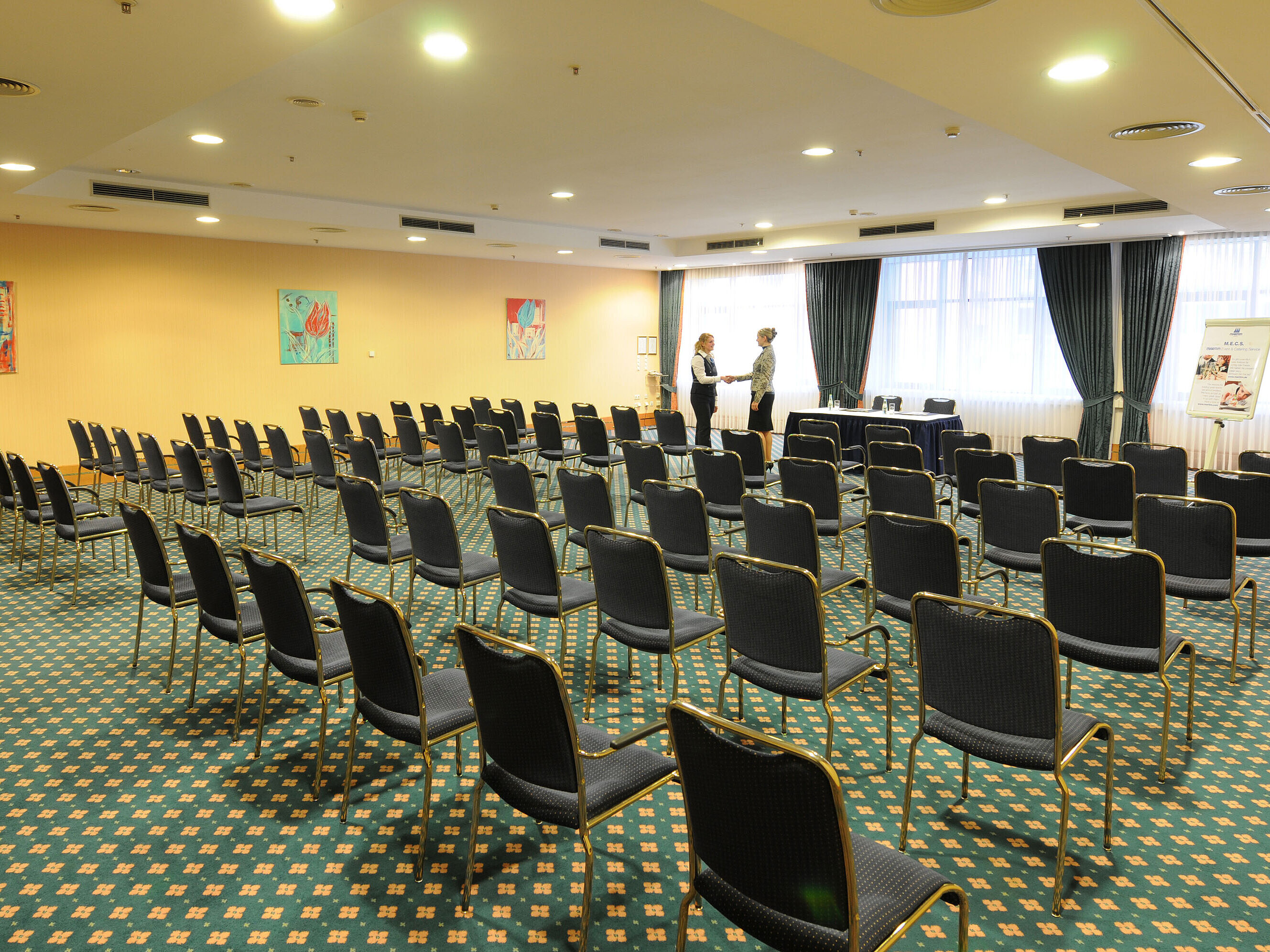 Large conference room with row seating and professional setup at Maritim Hotel Magdeburg.
