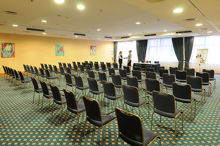 Large conference room with row seating and professional setup at Maritim Hotel Magdeburg.