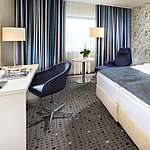 Superior room at Maritim Hotel Bonn with modern design, cozy bed, desk, and stylish curtains. 