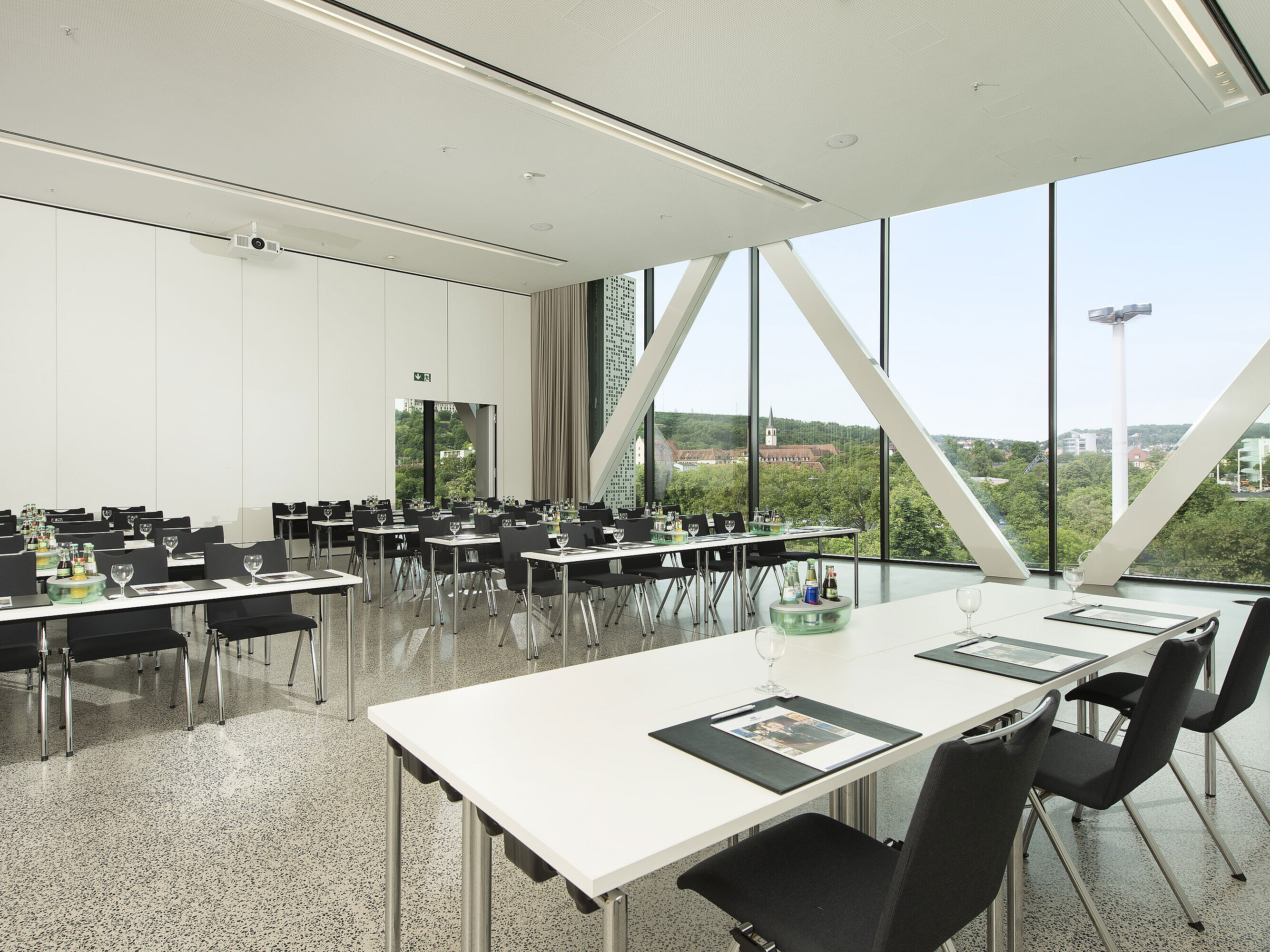 Conference room at Maritim Hotel Würzburg with rows of chairs, daylight and city view