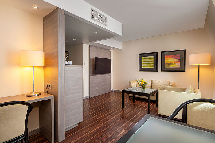 Junior Suite at Maritim Hotel Königswinter with living area, seating, desk and open-plan layout.
