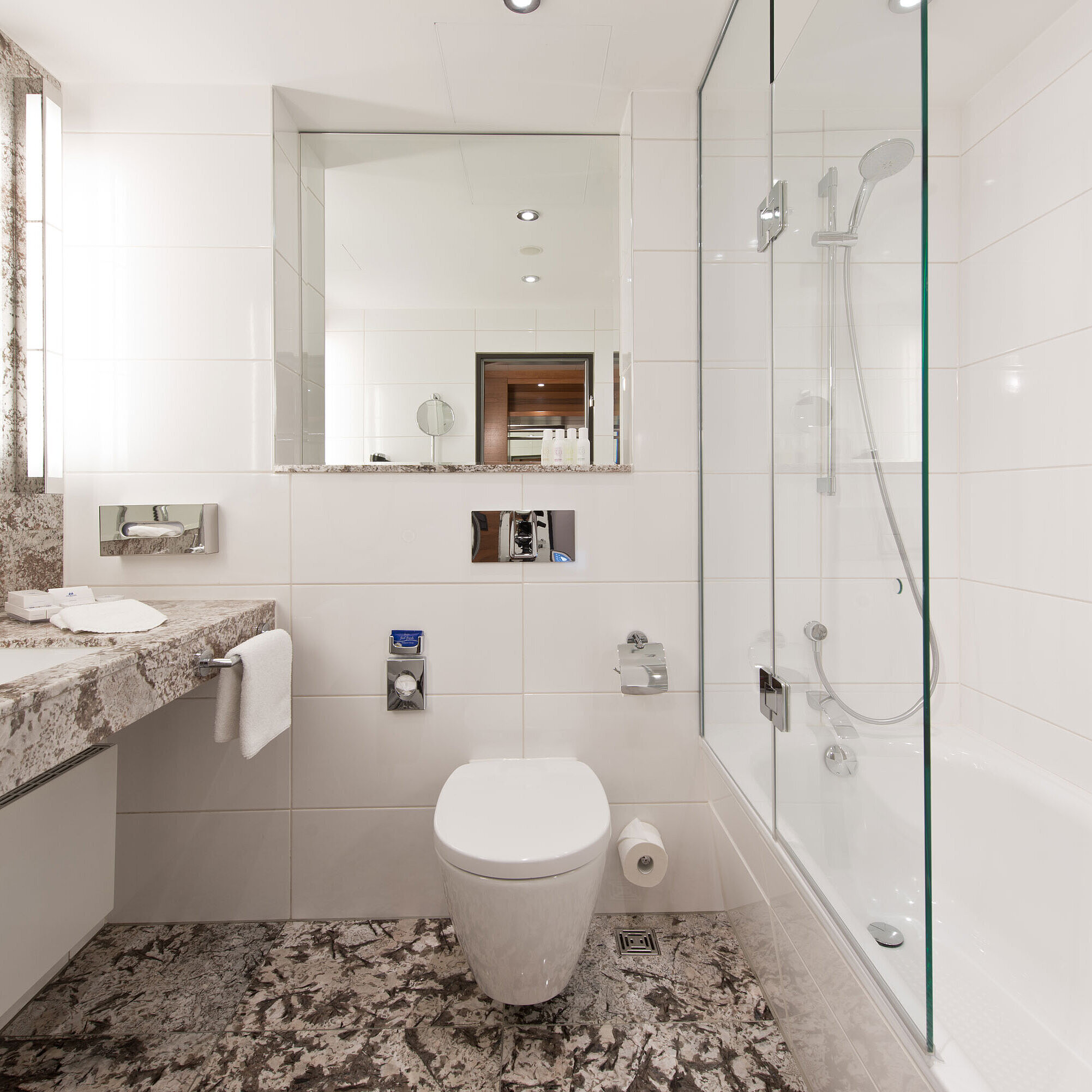Bright bathroom at Maritim Hotel Bad Homburg with modern bathtub and elegant marble design.