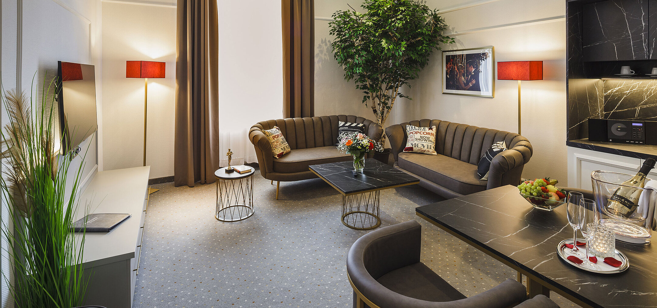 Spacious suite with living area and dining table at Hansa Hotel Wiesbaden