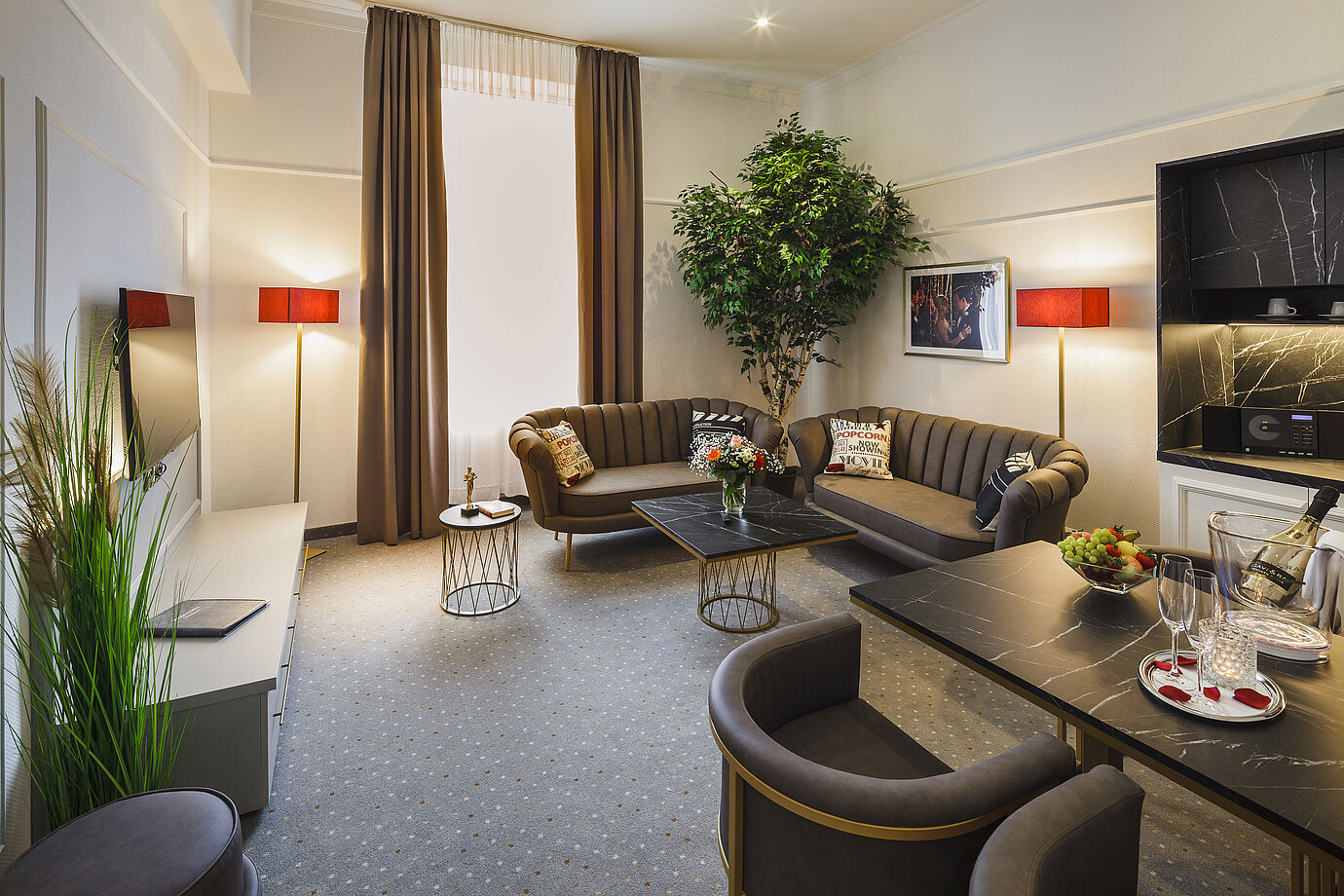 Spacious suite with living area and dining table at Hansa Hotel Wiesbaden