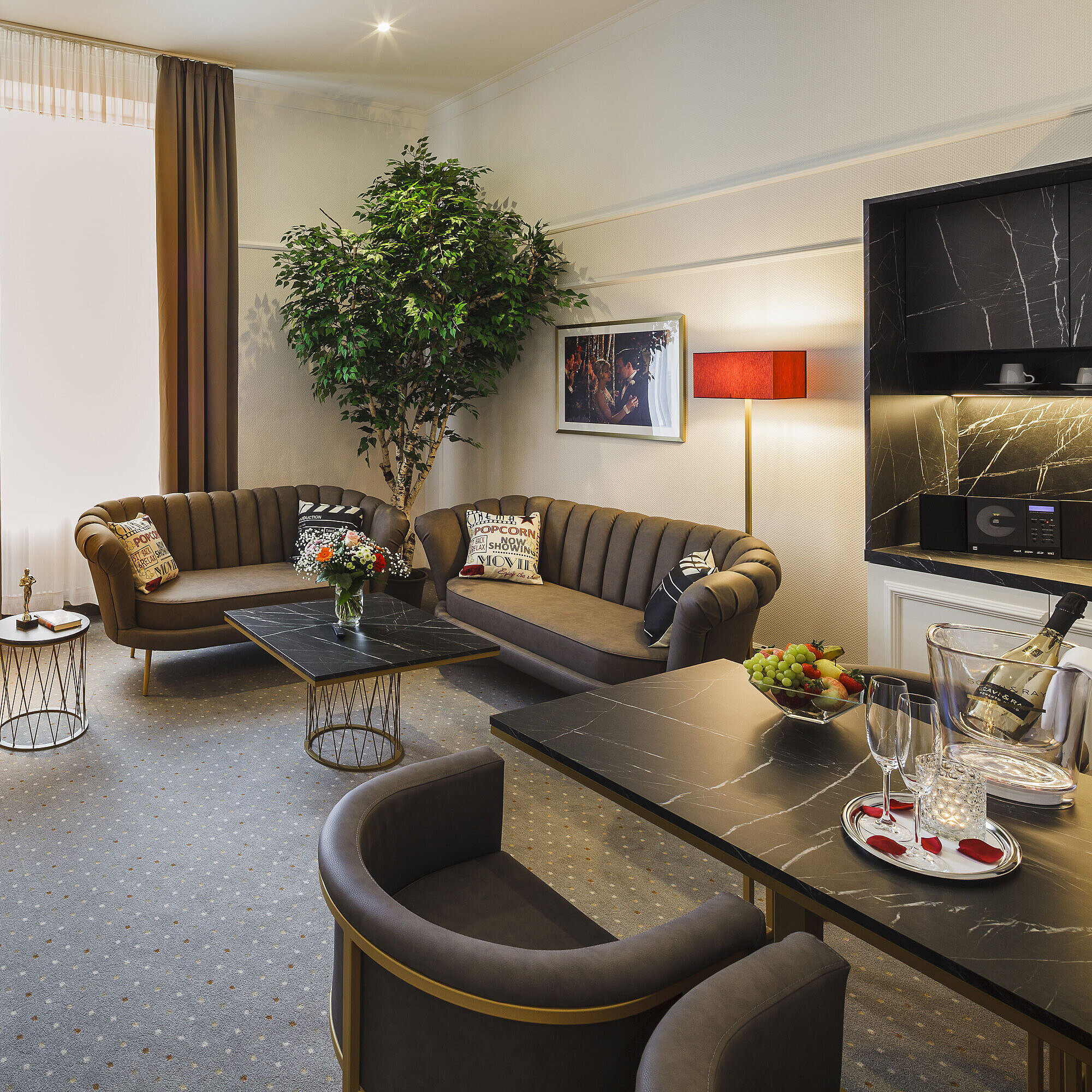 Spacious suite with living area and dining table at Hansa Hotel Wiesbaden