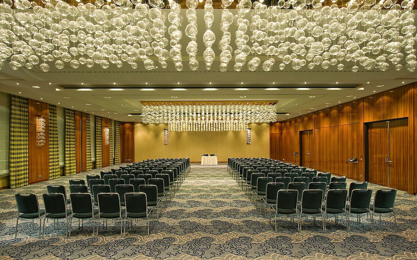 Elegant event hall at Maritim Hotel Düsseldorf with artistic lighting and row seating, ideal for events and conferences.