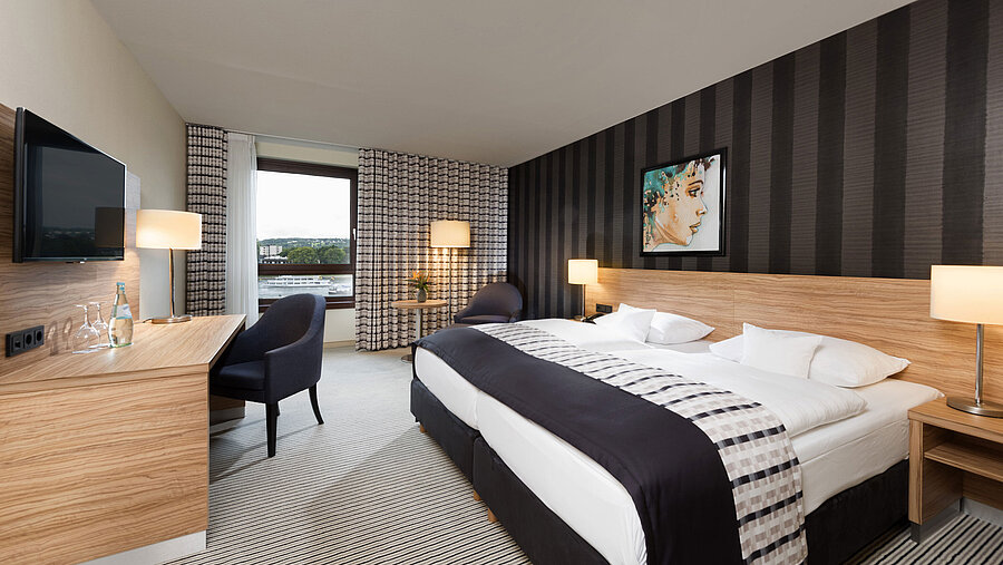 Elegant twin room at Maritim Hotel Königswinter with Rhine view, modern design, and stylish interior.