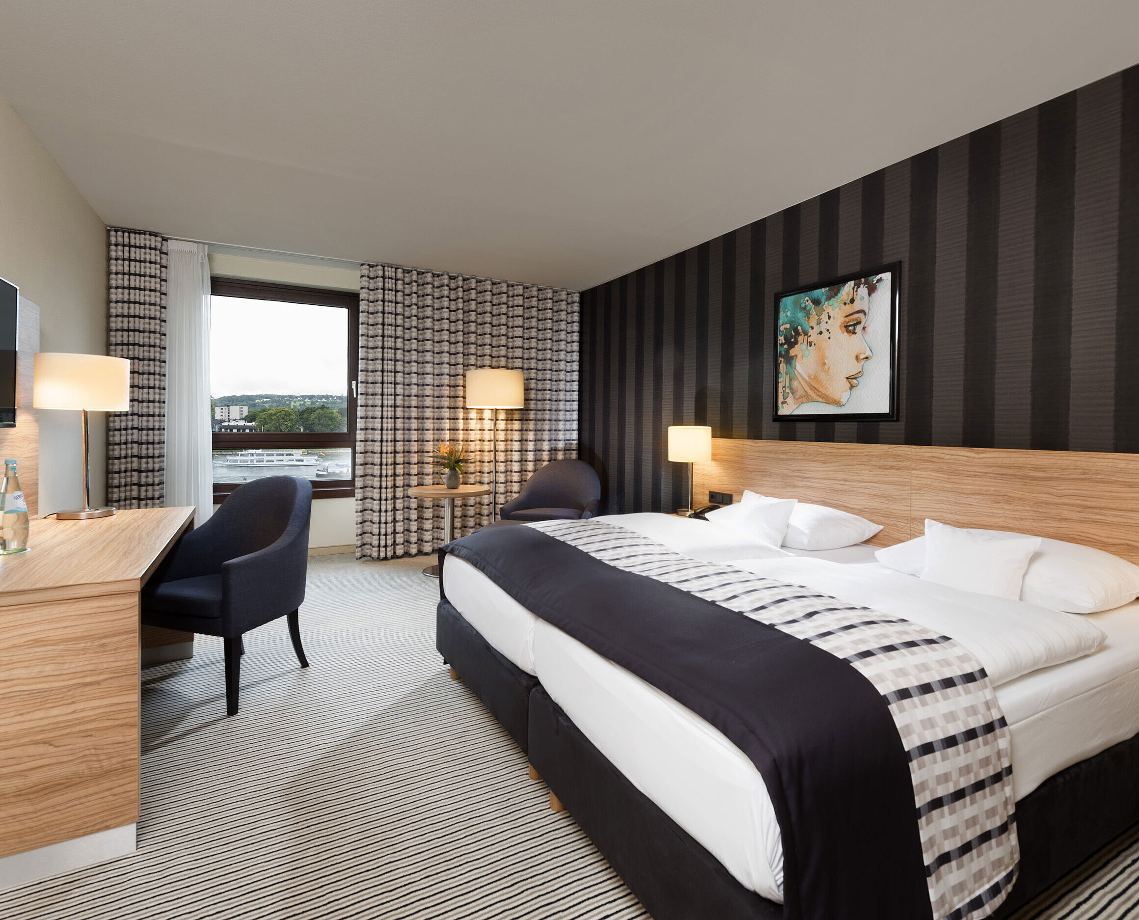 Elegant twin room at Maritim Hotel Königswinter with Rhine view, modern design, and stylish interior.