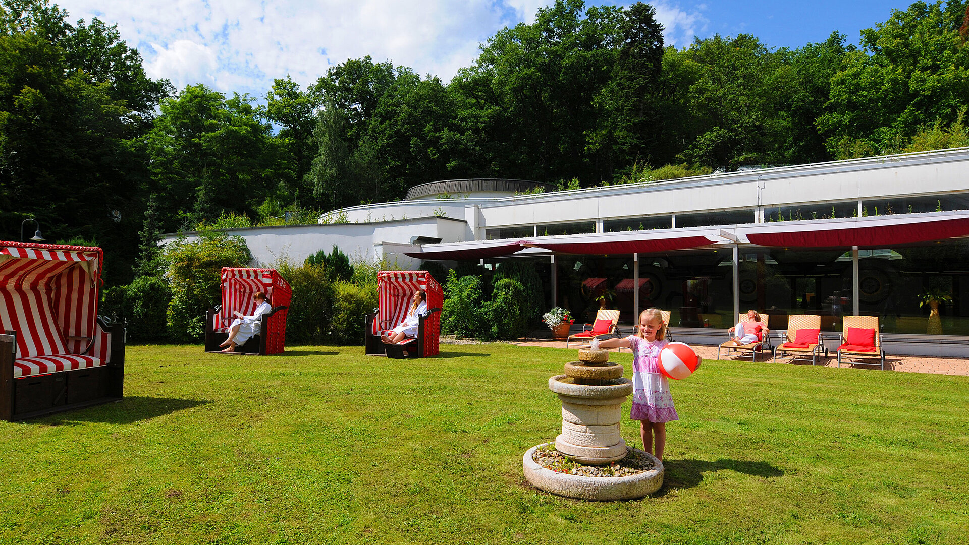Garden area at Maritim Hotel Bad Wildungen with beach chairs, loungers and play area