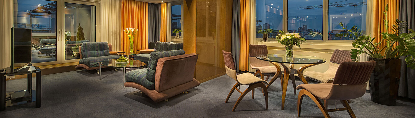 Elegant living room in the Presidential Suite at Maritim proArte Hotel Berlin with stylish lighting and view.