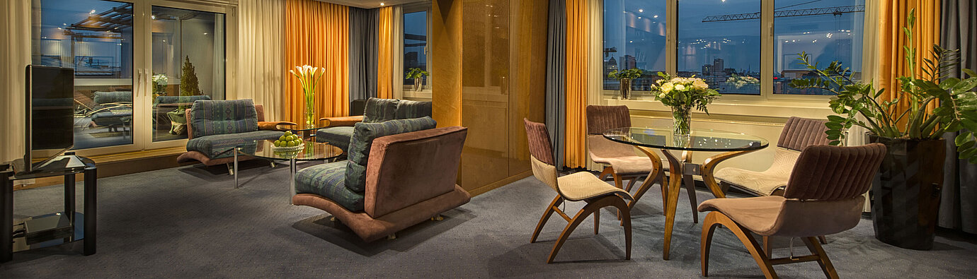 Elegant living room in the Presidential Suite at Maritim proArte Hotel Berlin with stylish lighting and view.