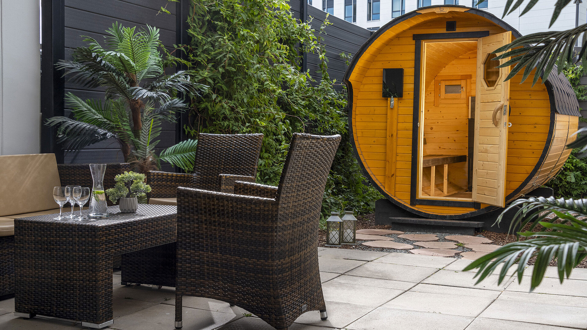Cosy outdoor area with seating and barrel sauna at Maritim Hotel Travemünde