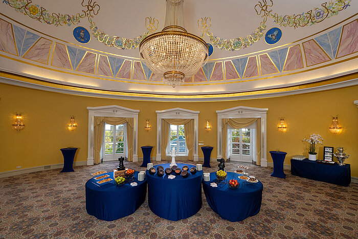 Fürst-Karl Dome Hall with round domed ceiling, chandelier, buffet setup and elegantly decorated room.
