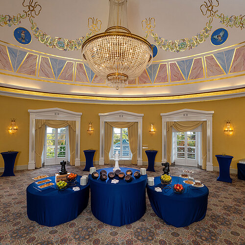 Fürst-Karl Dome Hall with round domed ceiling, chandelier, buffet setup and elegantly decorated room.