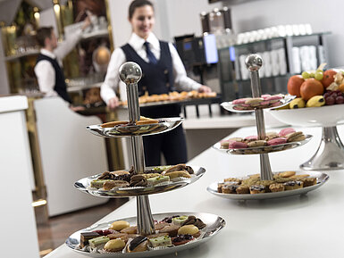 Selection of snacks, fruit and pastries with staff in the conference area of Maritim Hotel Stuttgart