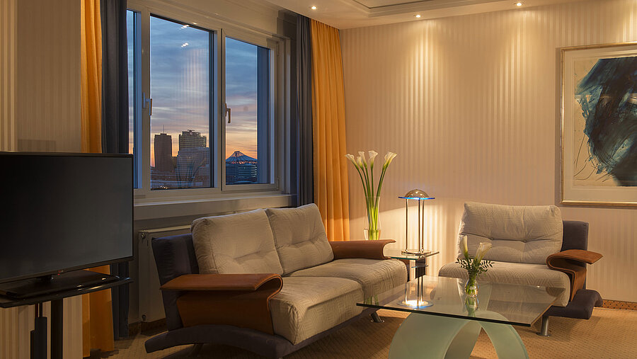 Seating area with sunset view in the Kuckei Suite at Maritim proArte Hotel Berlin.