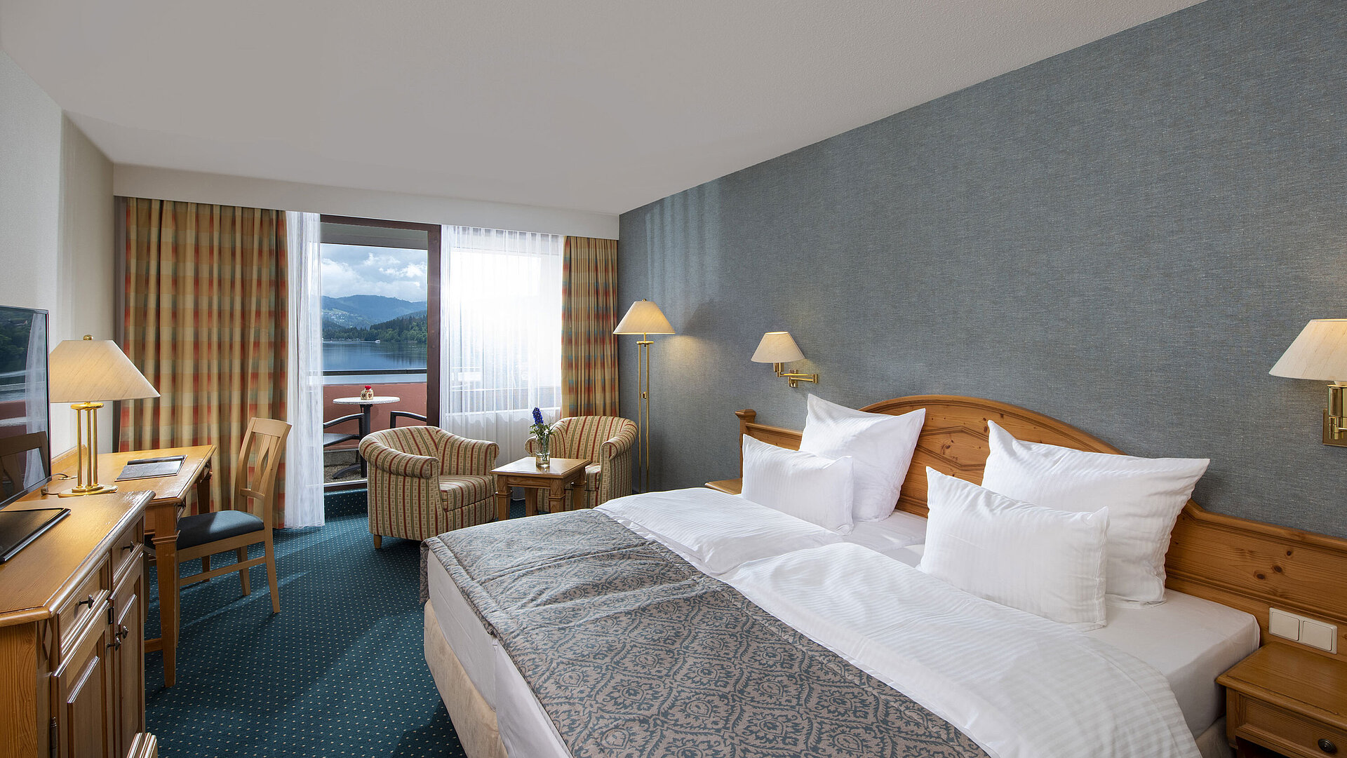 Spacious room at Maritim TitiseeHotel with seating area and view of Lake Titisee