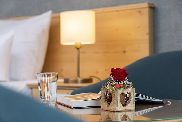 Red rose in heart-shaped wooden vase in a room at Maritim TitiseeHotel