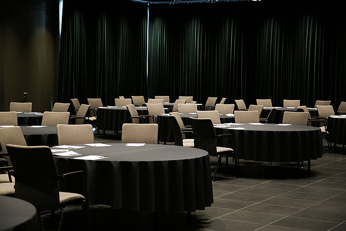 Meeting room with round tables, black tablecloths and chairs at Maritim Hotel Plaza Tirana