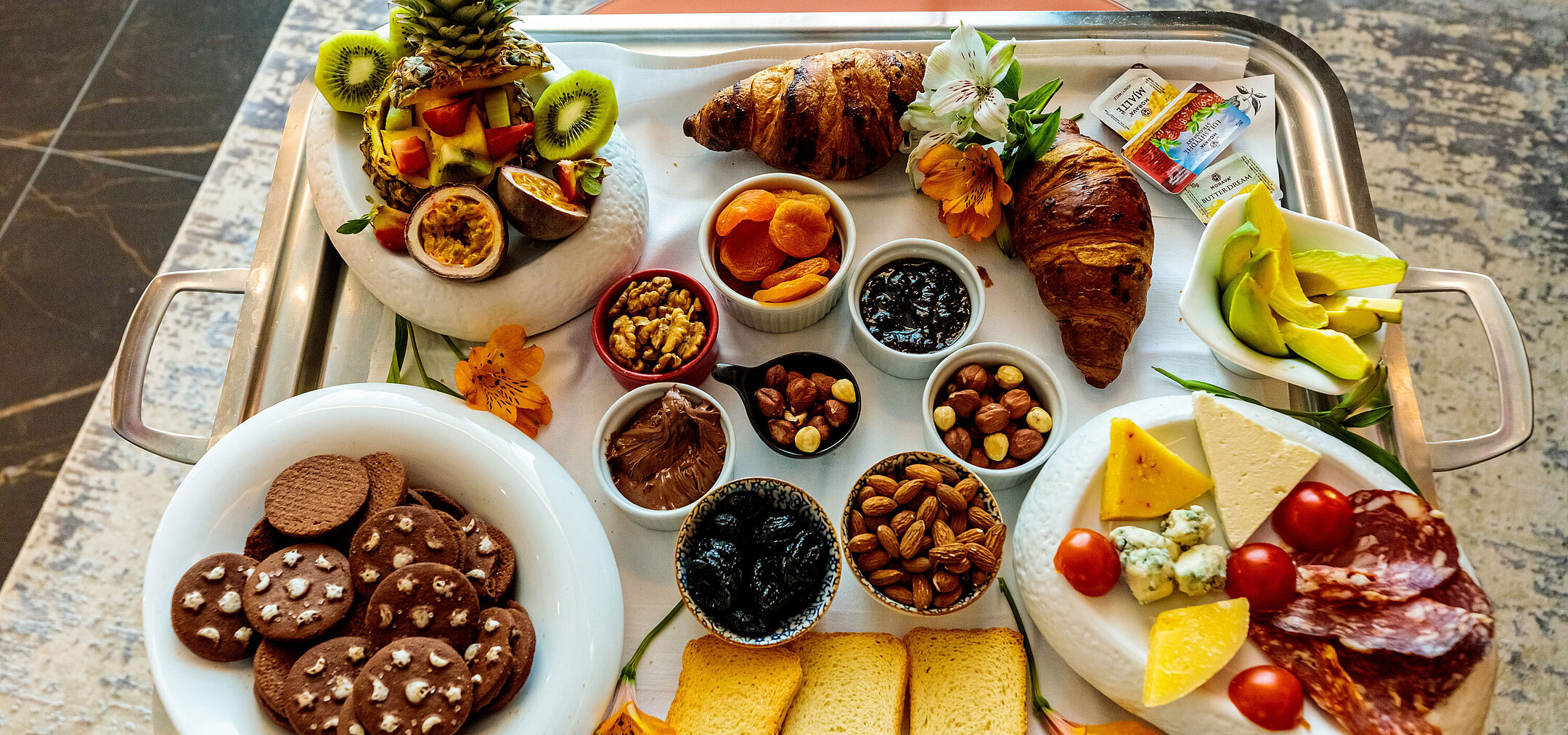 Breakfast tray at Maritim Resort Marina Bay with fresh fruit, pastries, nuts, cheese and cold cuts