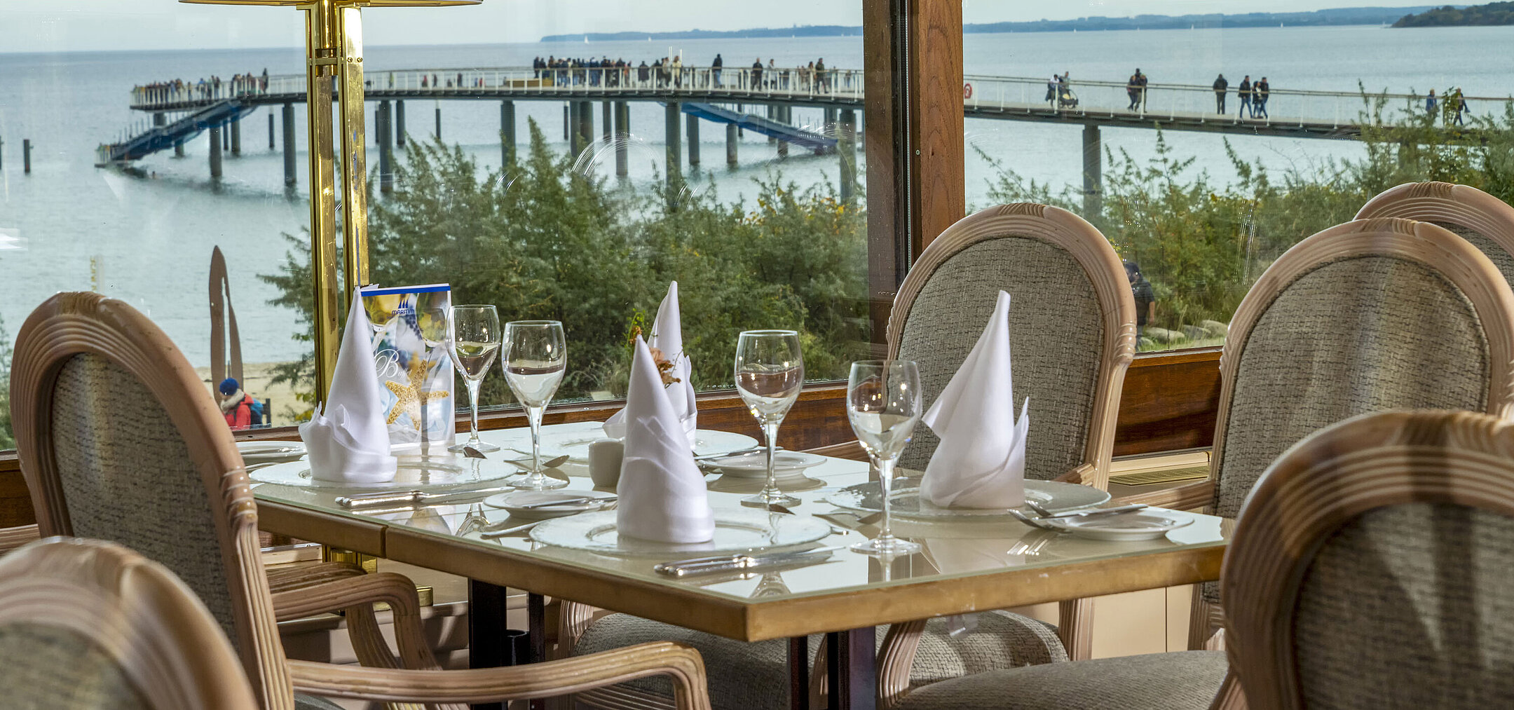 Elegant restaurant table with a view of the Baltic Sea and pier, Maritim Hotel Timmendorfer Strand.