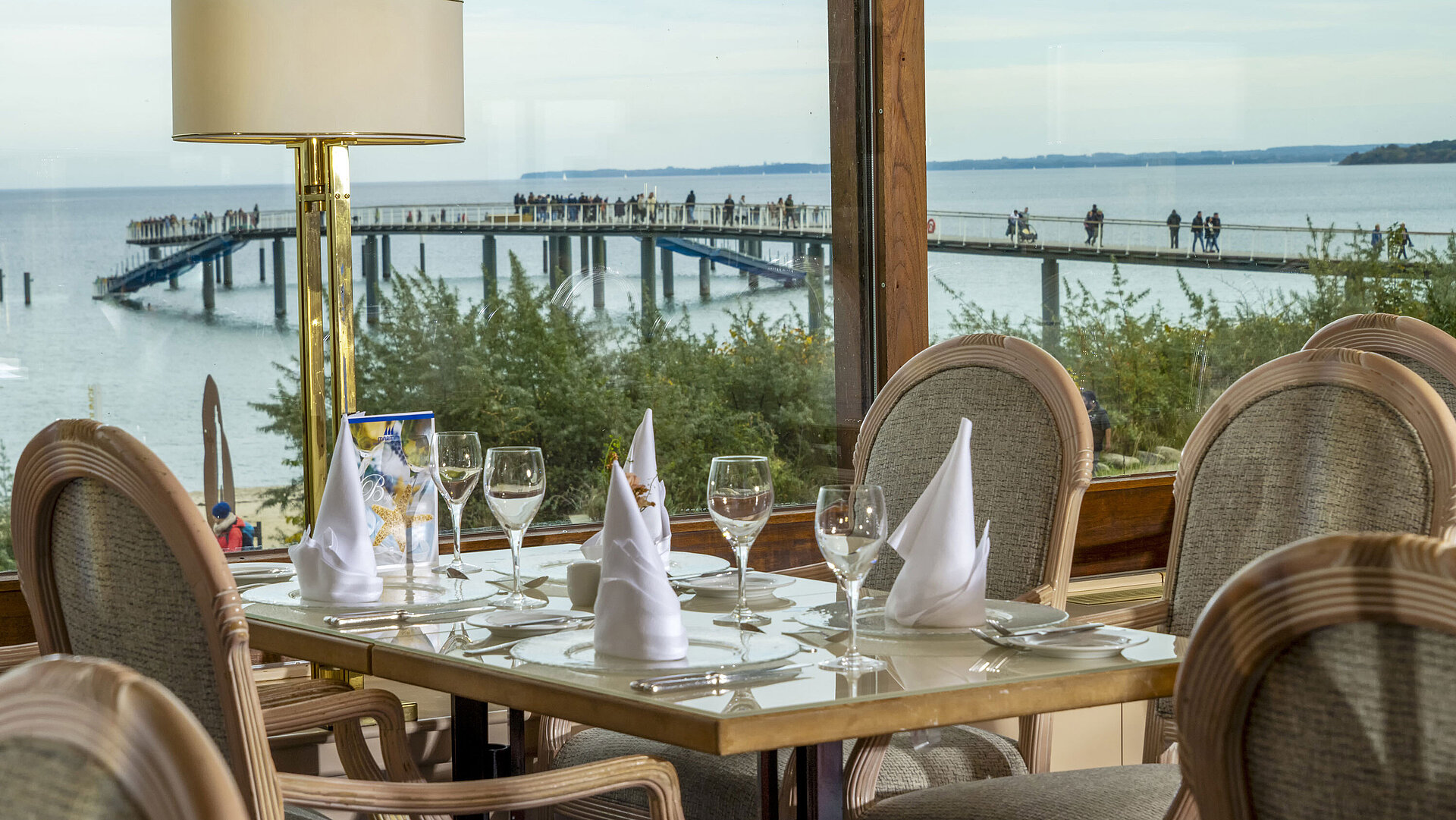 Elegant restaurant table with a view of the Baltic Sea and pier, Maritim Hotel Timmendorfer Strand.