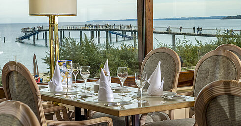 Elegant restaurant table with a view of the Baltic Sea and pier, Maritim Hotel Timmendorfer Strand.
