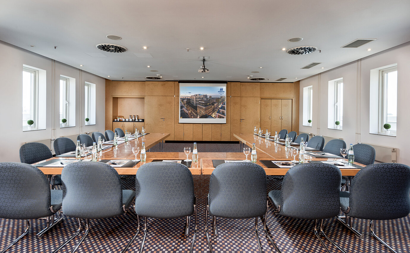 Meeting room with rectangular table setup and modern presentation technology at Maritim proArte Hotel Berlin.