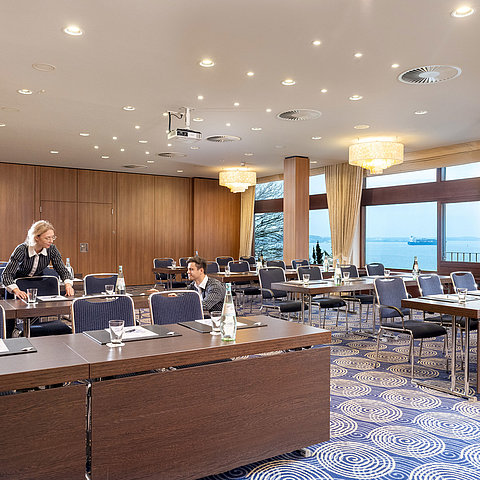 Saal Kiel in the Maritim Hotel Kiel, large conference room with sea view, friendly staff set up the tables.