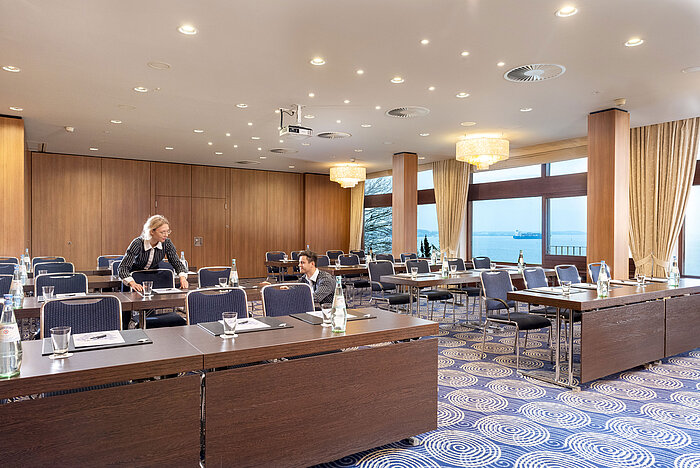 Saal Kiel in the Maritim Hotel Kiel, large conference room with sea view, friendly staff set up the tables.