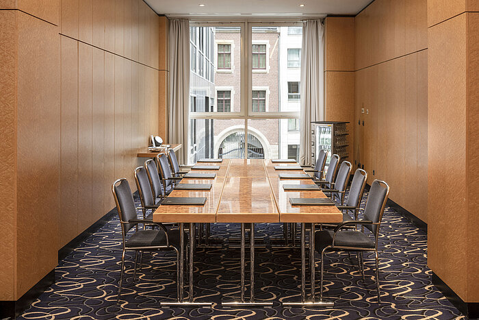 Elegant conference room at Maritim proArte Hotel Berlin with table and chairs in a modern setting.